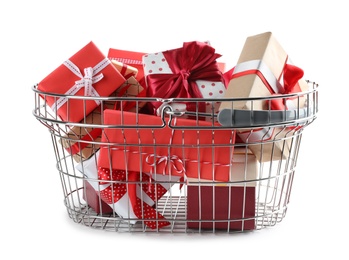 Photo of Shopping basket full of gift boxes on white background