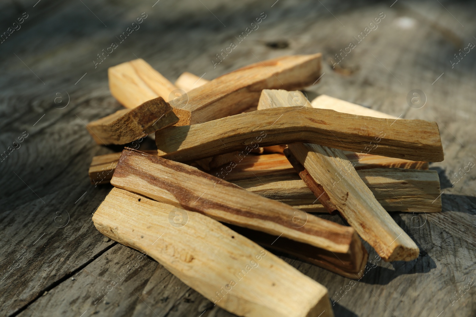 Photo of Palo santo sticks on wooden table, closeup