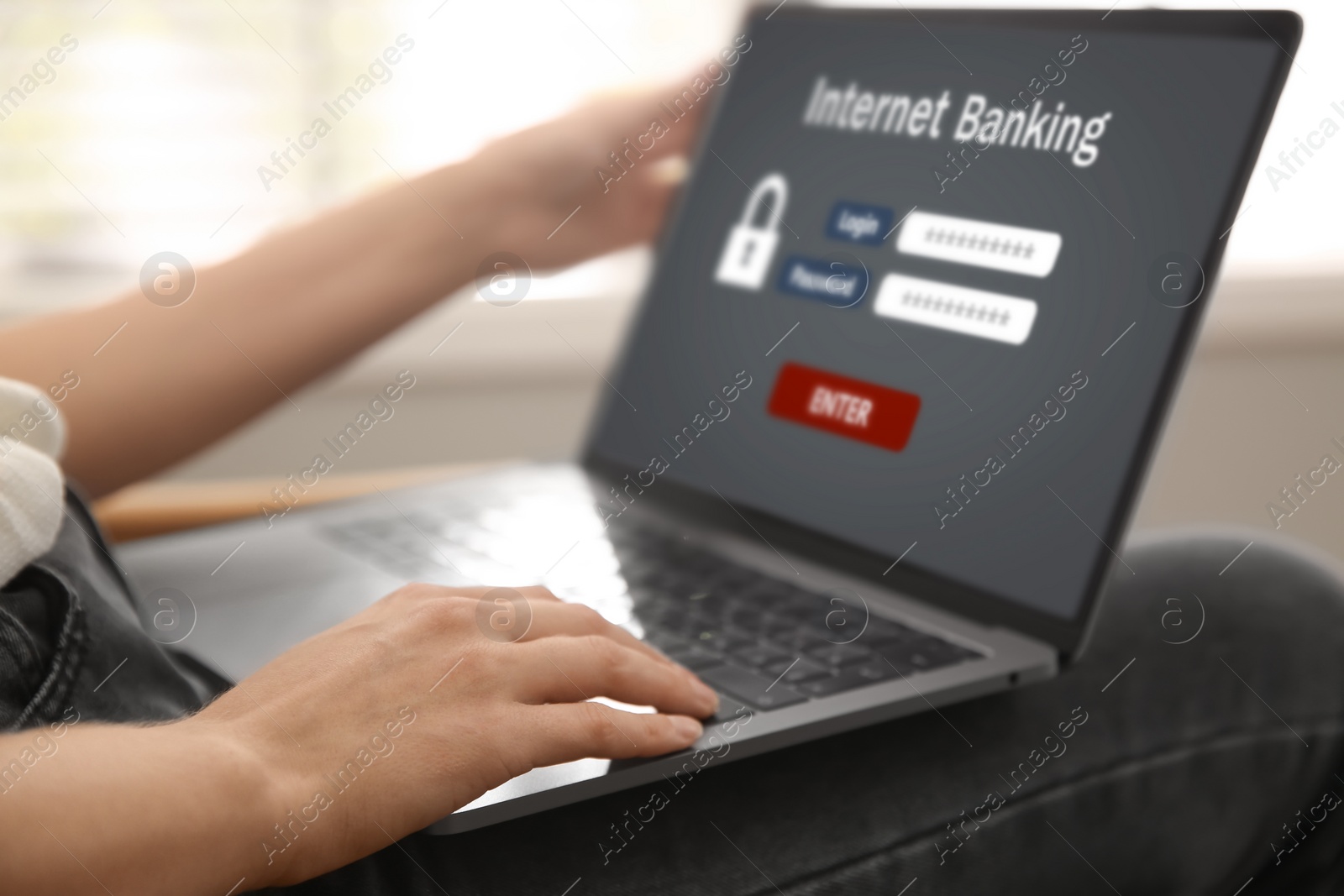 Image of Woman using online banking application on laptop indoors, closeup