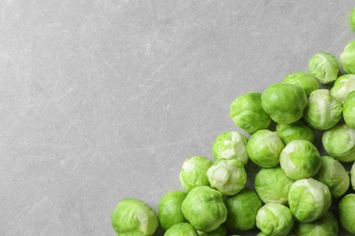 Photo of Fresh Brussels sprouts on grey background, top view with space for text