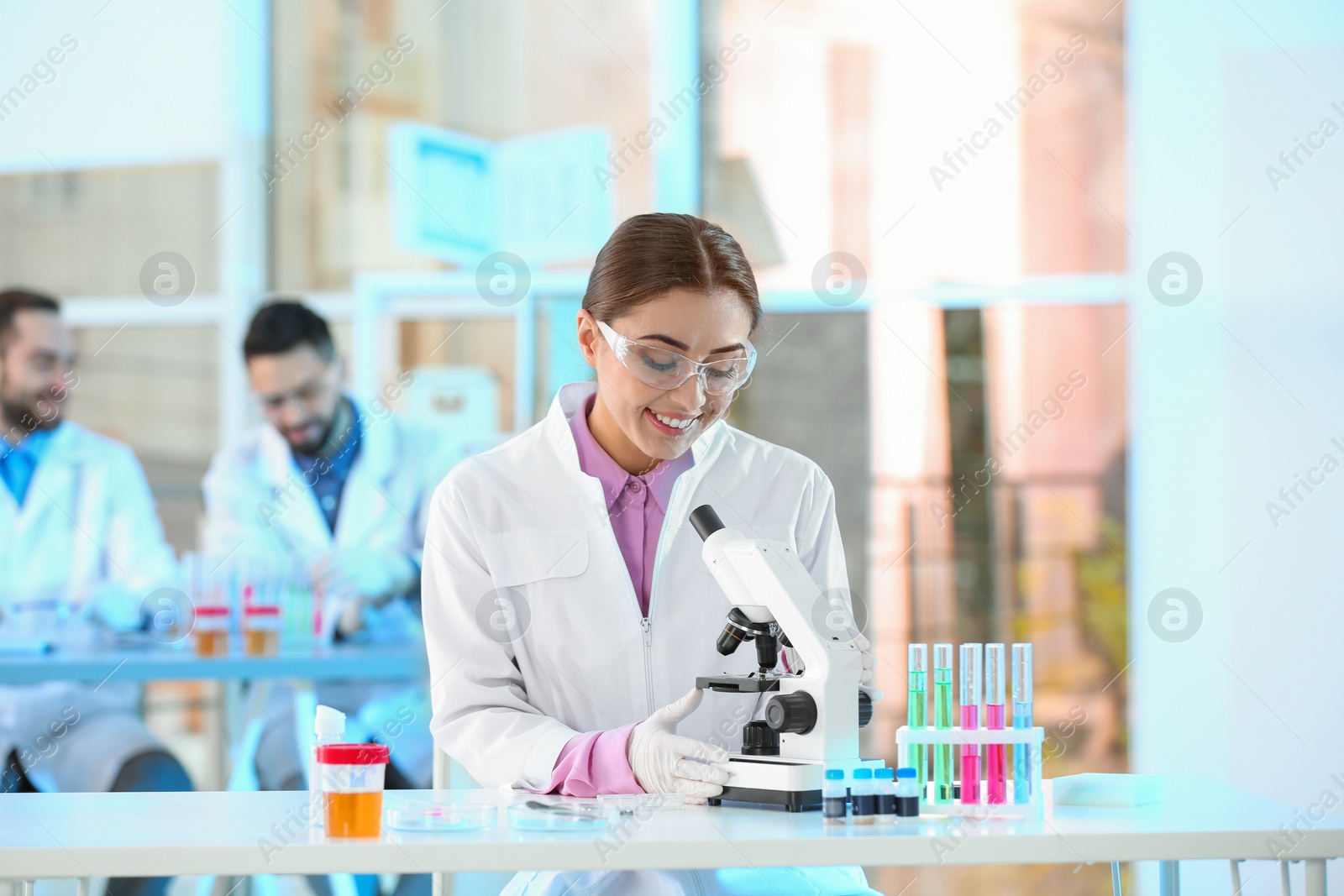 Photo of Young scientist working with microscope in laboratory. Chemical analysis