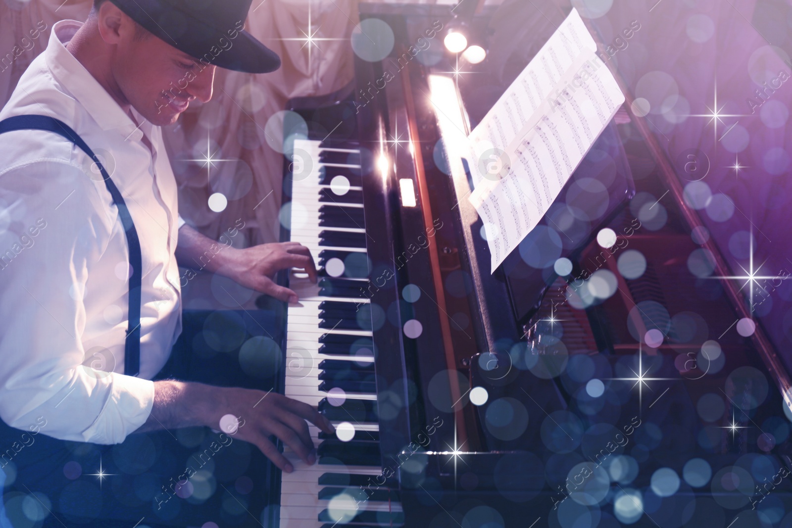 Image of Man playing grand piano indoors. Bokeh effect