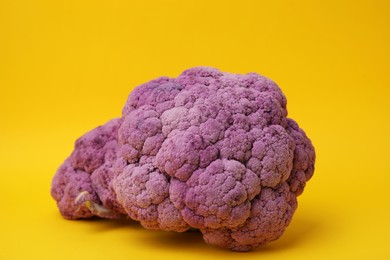 Photo of Fresh raw purple cauliflowers on yellow background. Healthy food