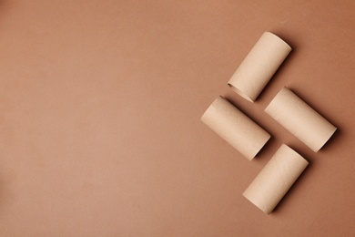 Photo of Flat lay composition with empty toilet paper rolls and space for text on color background