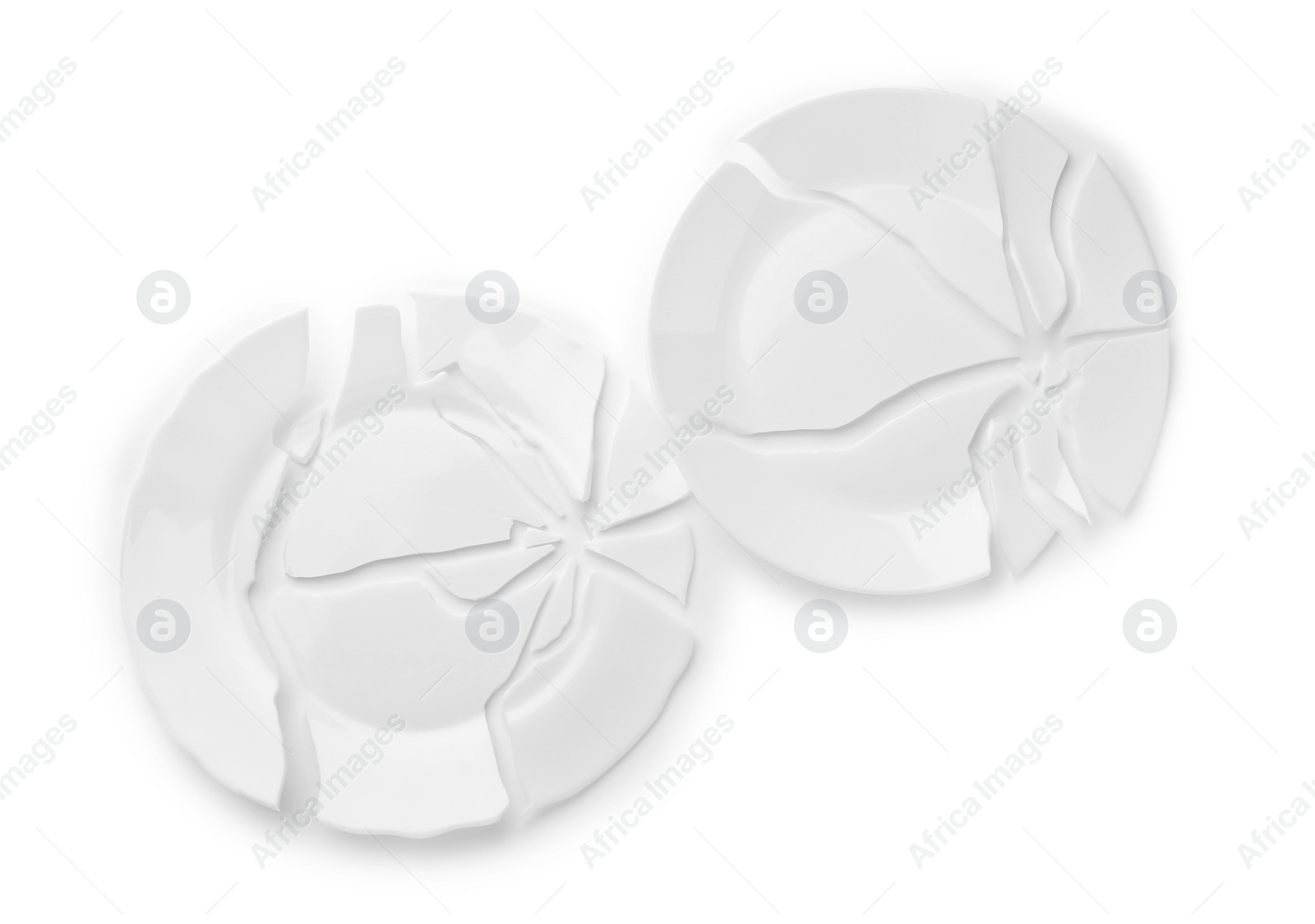 Photo of Two broken ceramic plates on white background, top view