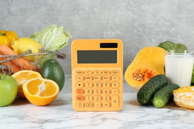 Photo of Calculator and food products on white marble table. Weight loss concept