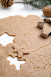 Photo of Homemade Christmas biscuits. Raw dough and cookie cutter on white table, closeup