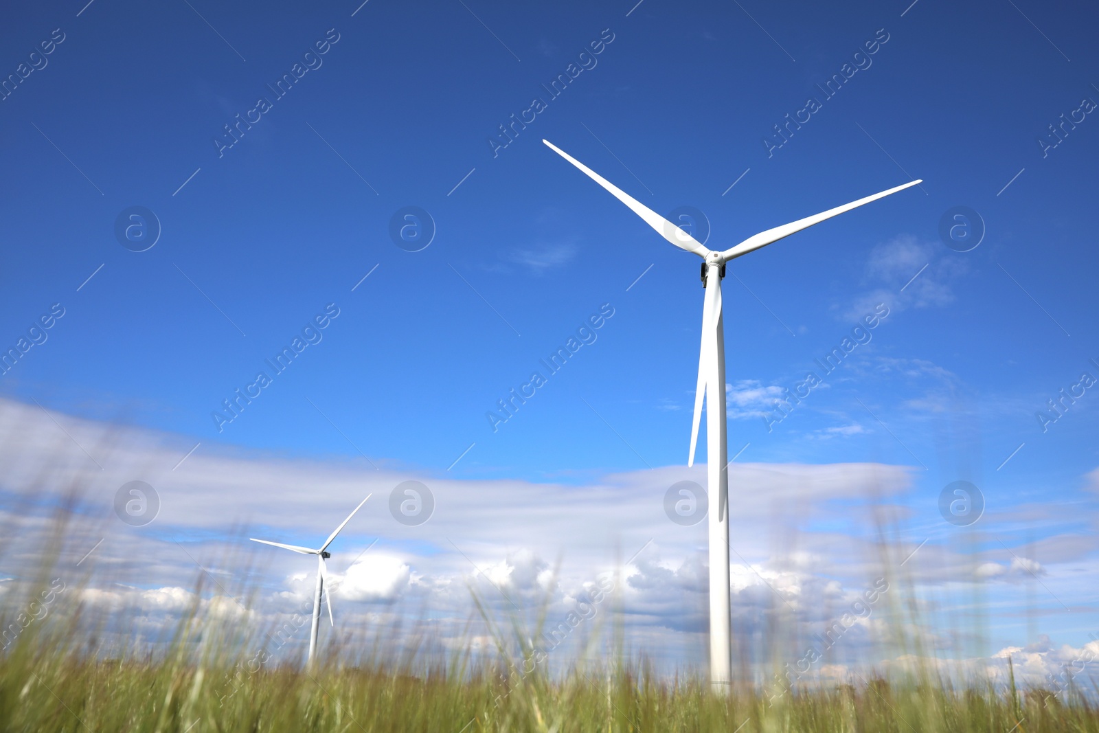 Photo of Beautiful view of field with wind turbines. Alternative energy source