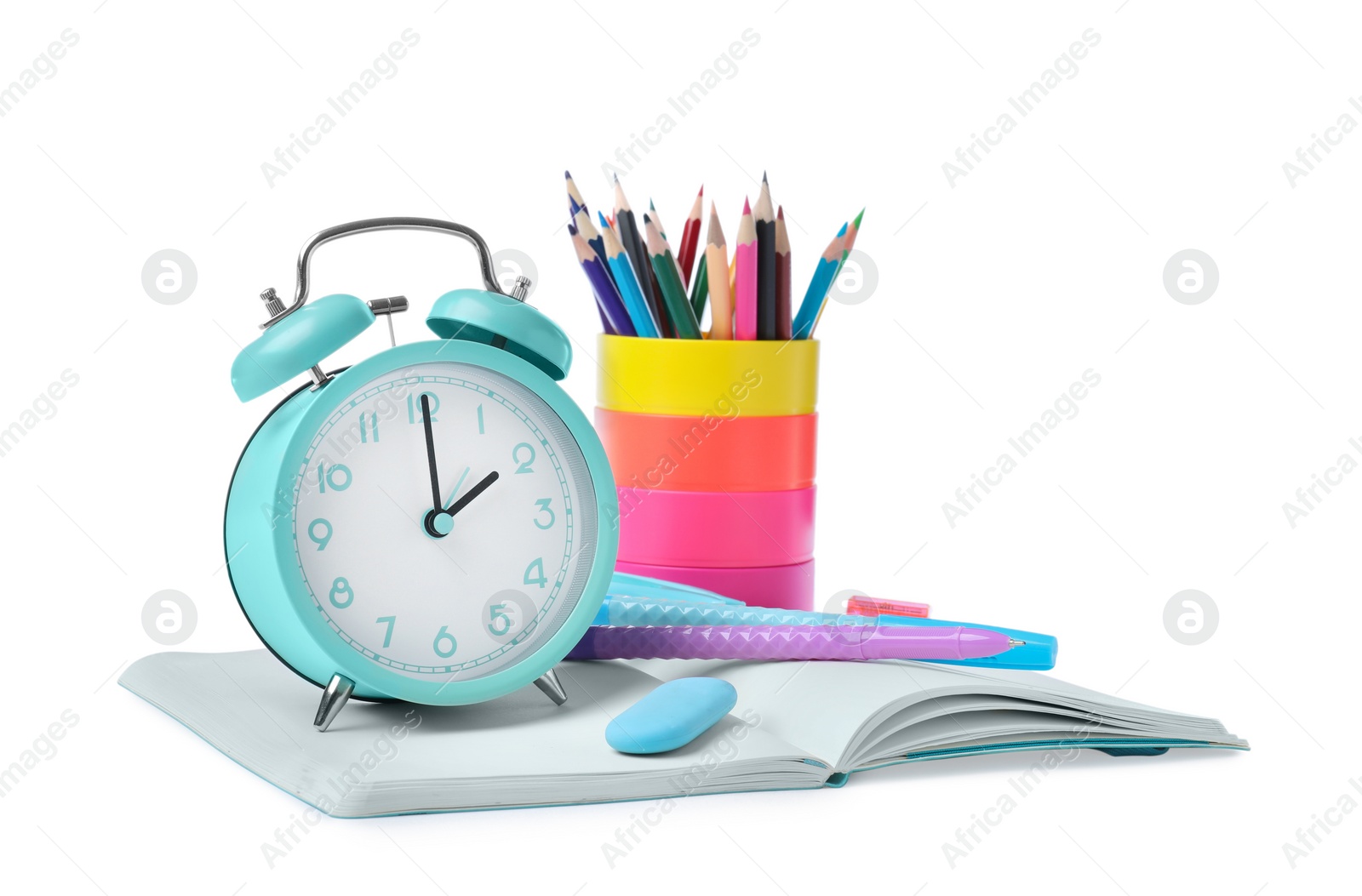 Photo of Turquoise alarm clock and different stationery on white background. School time