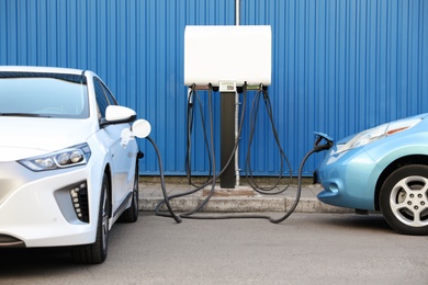 Charging modern electric cars from station outdoors