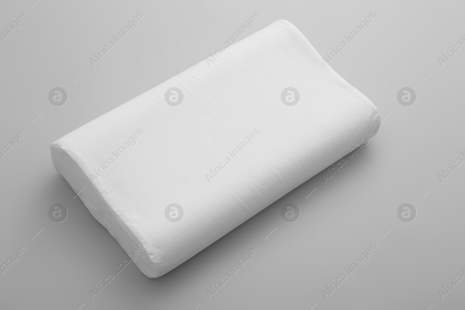 Photo of Clean soft orthopedic pillow on grey background