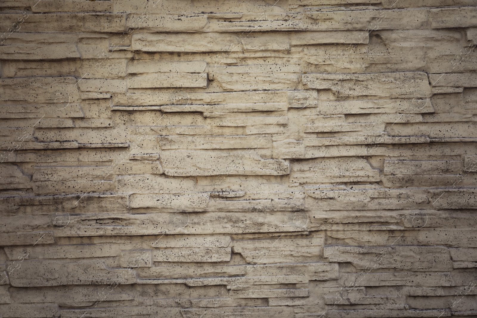 Photo of Texture of white stone wall as background, closeup