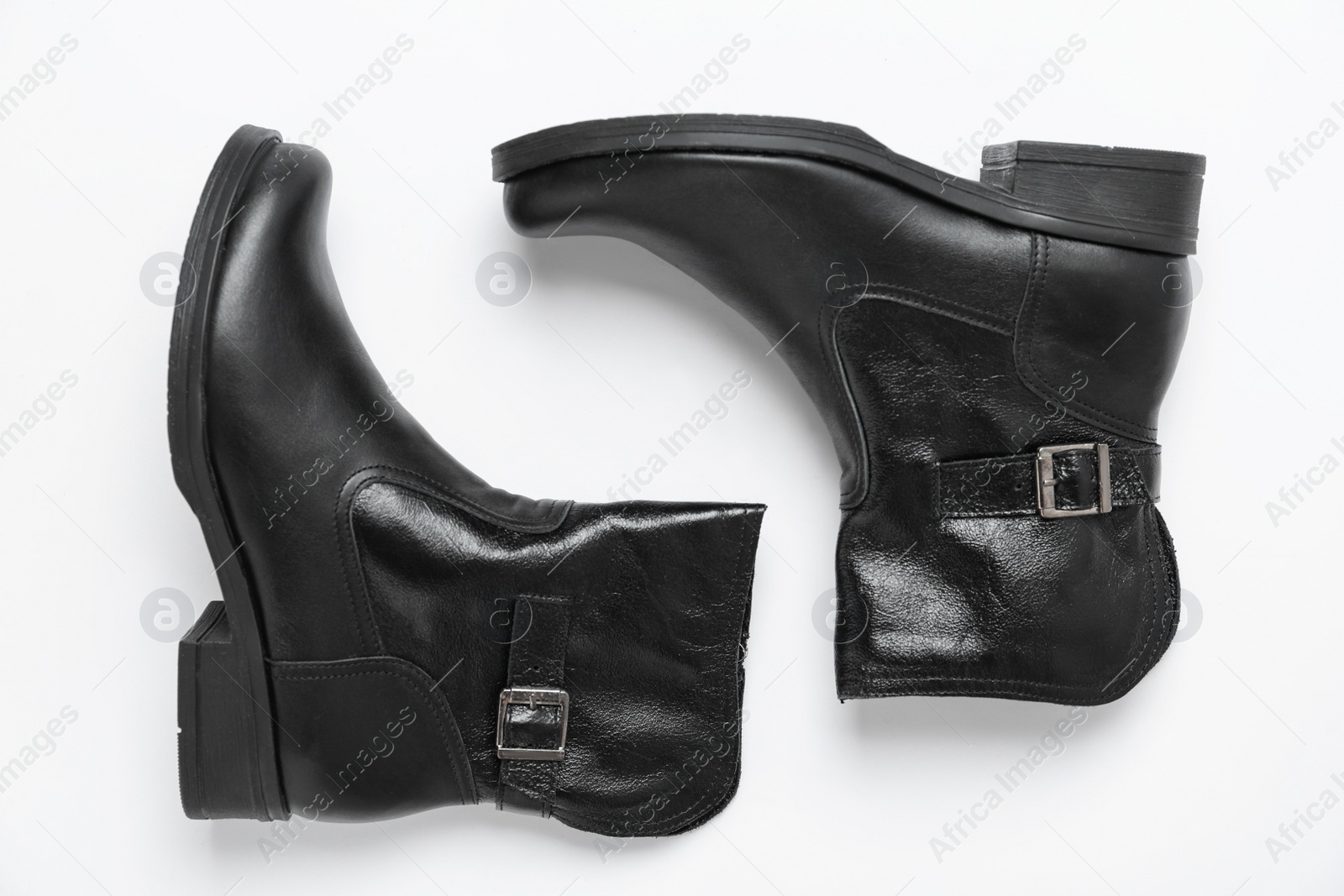 Photo of Stylish black female boots on white background, top view