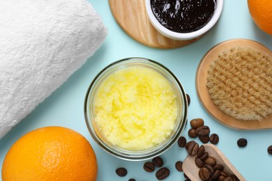 Photo of Flat lay composition with natural body scrubs and fresh ingredients on light blue background. Anti cellulite treatment