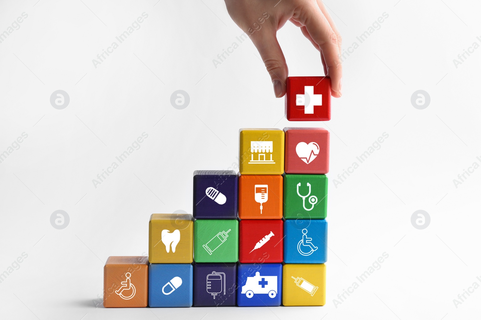 Image of Woman building stairs with colorful cubes on white background. Health insurance concept