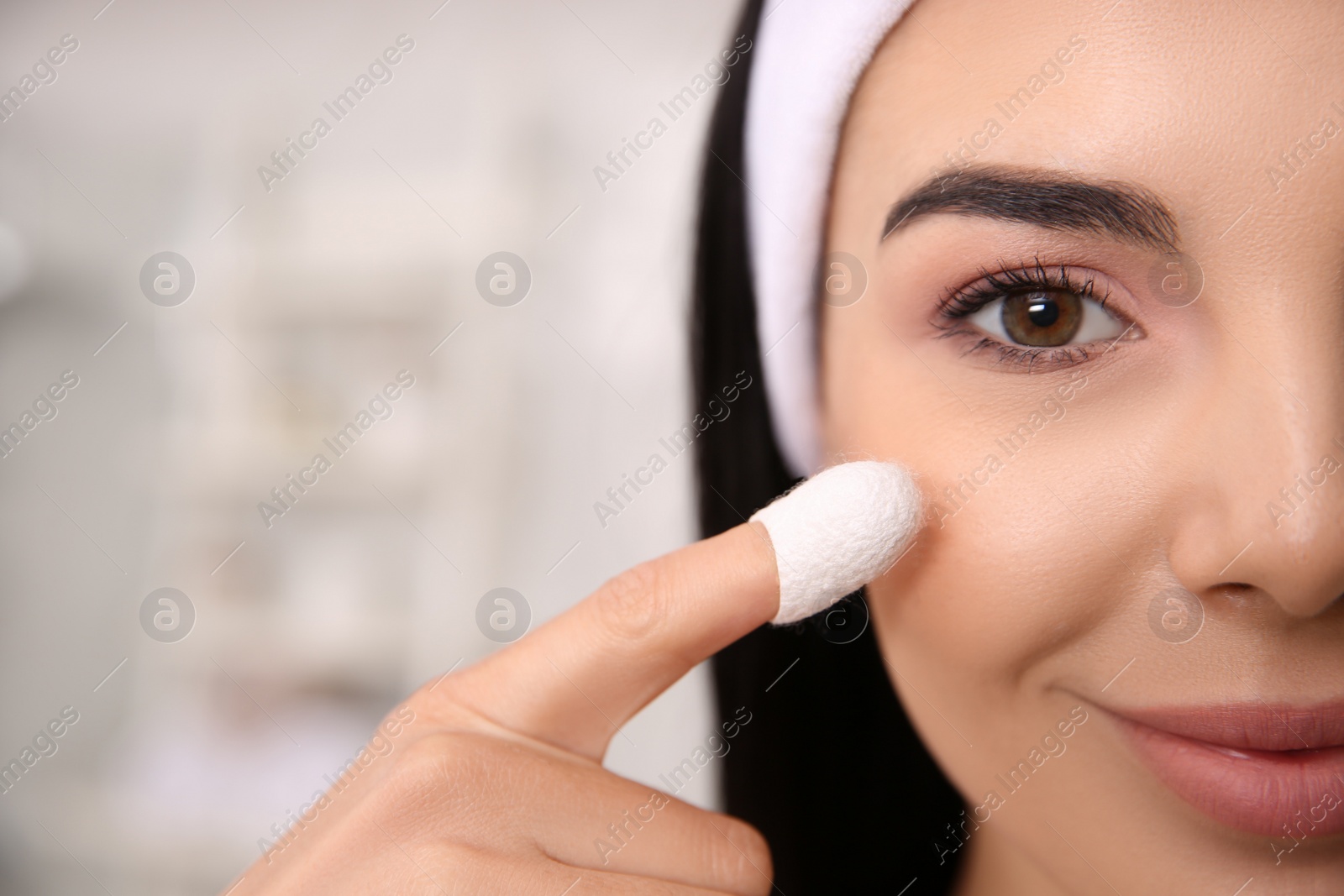 Photo of Woman using silkworm cocoon in skin care routine at home, closeup. Space for text