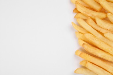 Delicious french fries on white background, flat lay. Space for text