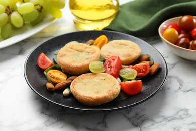 Photo of Plate with healthy dish high in vegetable fats on white marble table, closeup