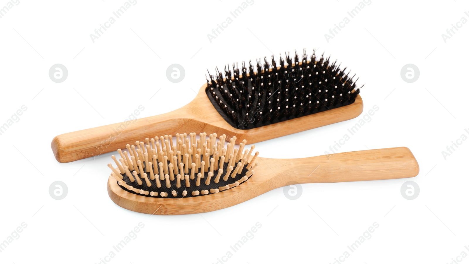 Photo of New wooden hair brushes isolated on white