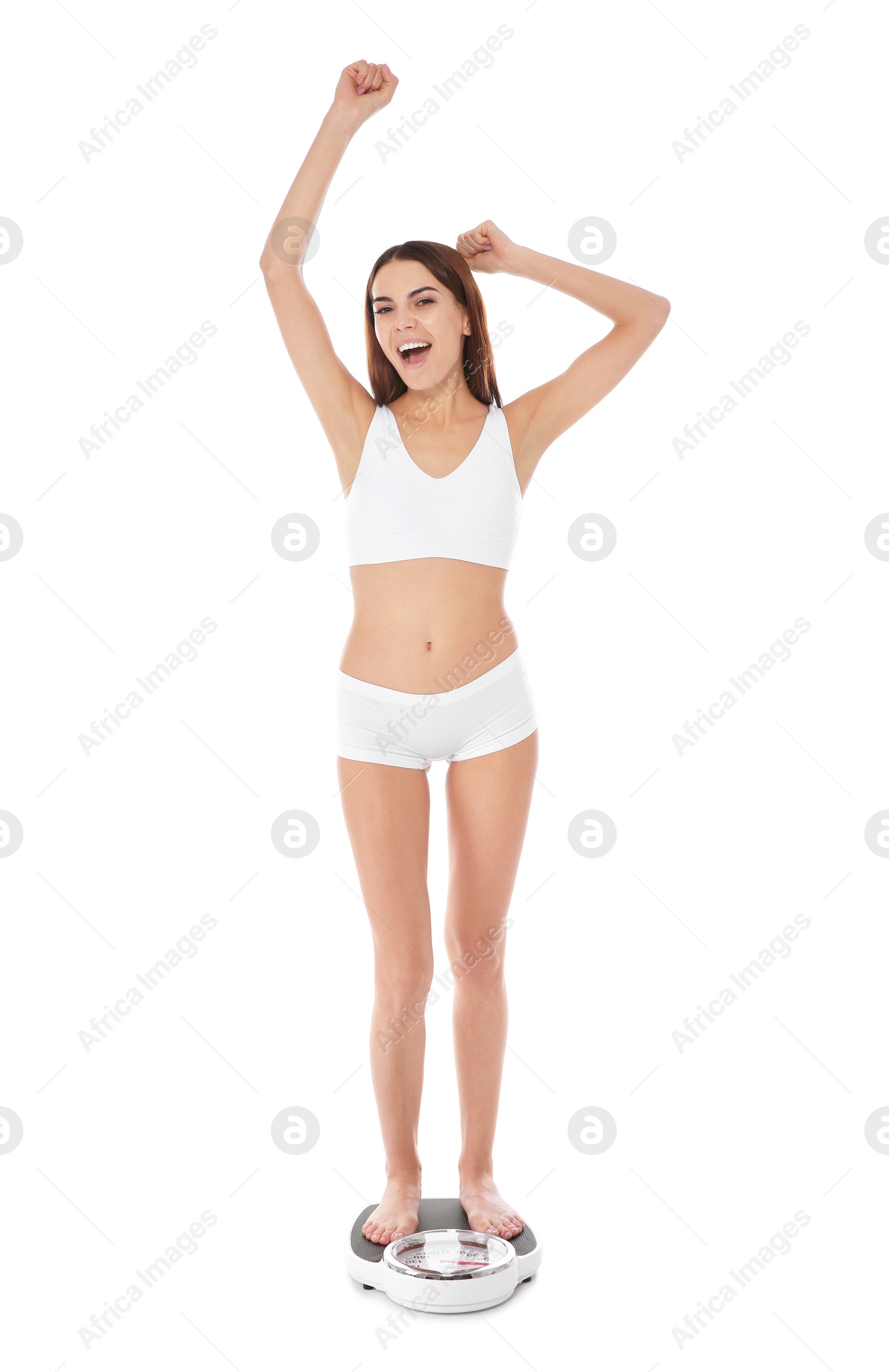 Photo of Slim woman standing on bathroom scale against white background. Weight loss