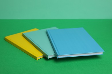 New stylish bright planners on color background
