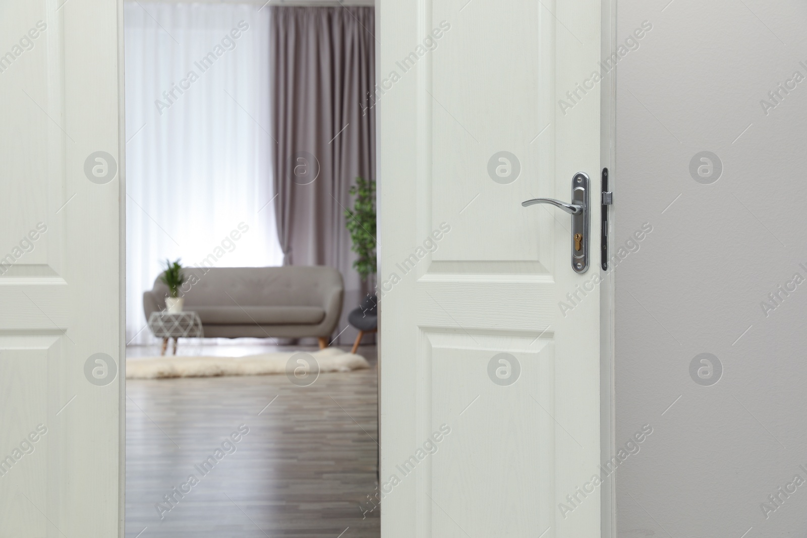 Photo of Stylish room interior, view through open door