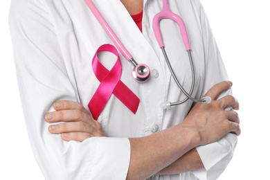 Photo of Female doctor with pink ribbon and stethoscope on white background, closeup. Breast cancer concept