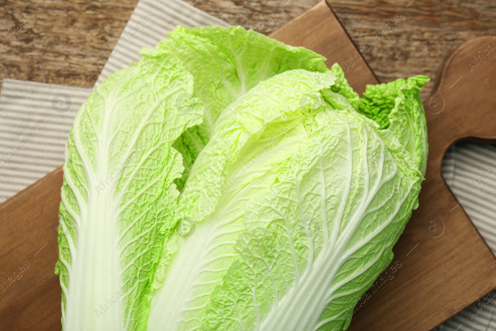 Photo of Fresh ripe Chinese cabbage on wooden table, top view