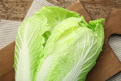 Photo of Fresh ripe Chinese cabbage on wooden table, top view