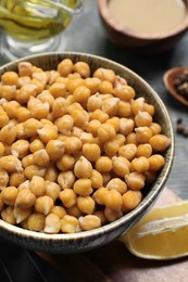 Delicious hummus on light blue wooden table, above view