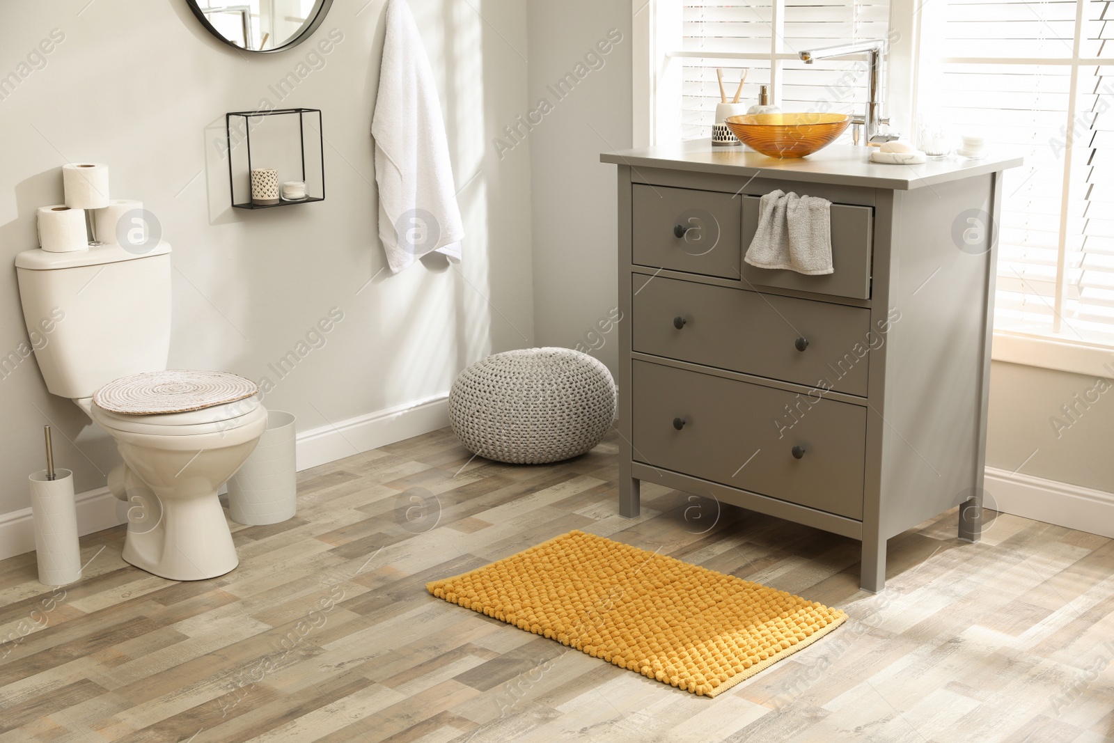 Photo of Mat near base cabinet with sink in bathroom