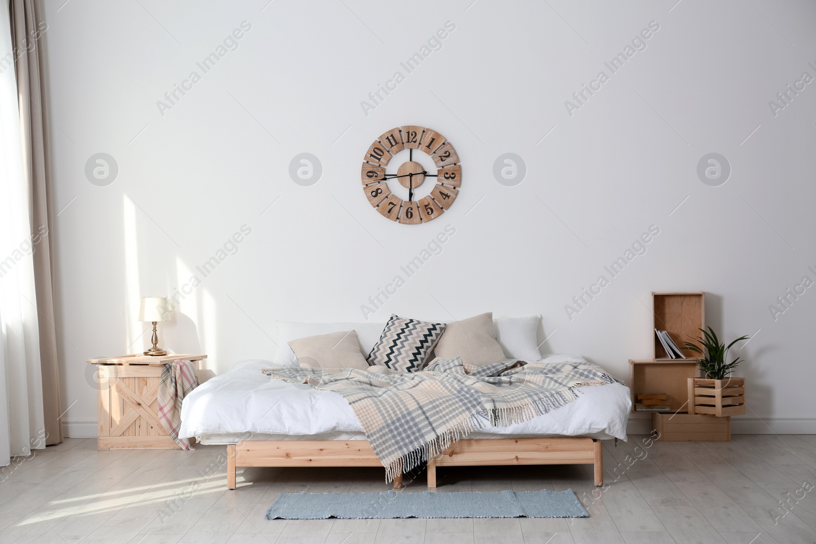 Photo of Bed with pillows and plaid in modern room interior