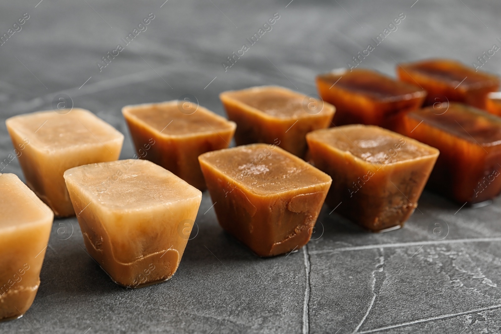 Photo of Composition with coffee ice cubes on grey table