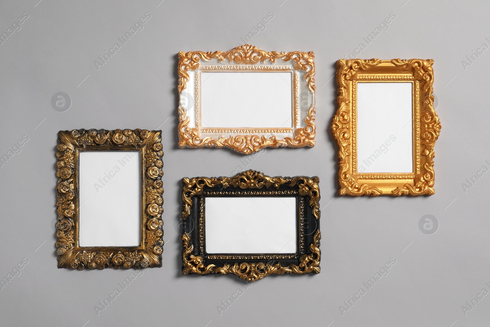 Photo of Empty vintage frames hanging on light gray wall