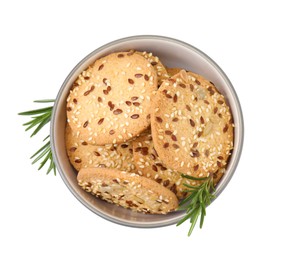 Photo of Round cereal crackers with flax, sunflower, sesame seeds and rosemary in bowl isolated on white, top view