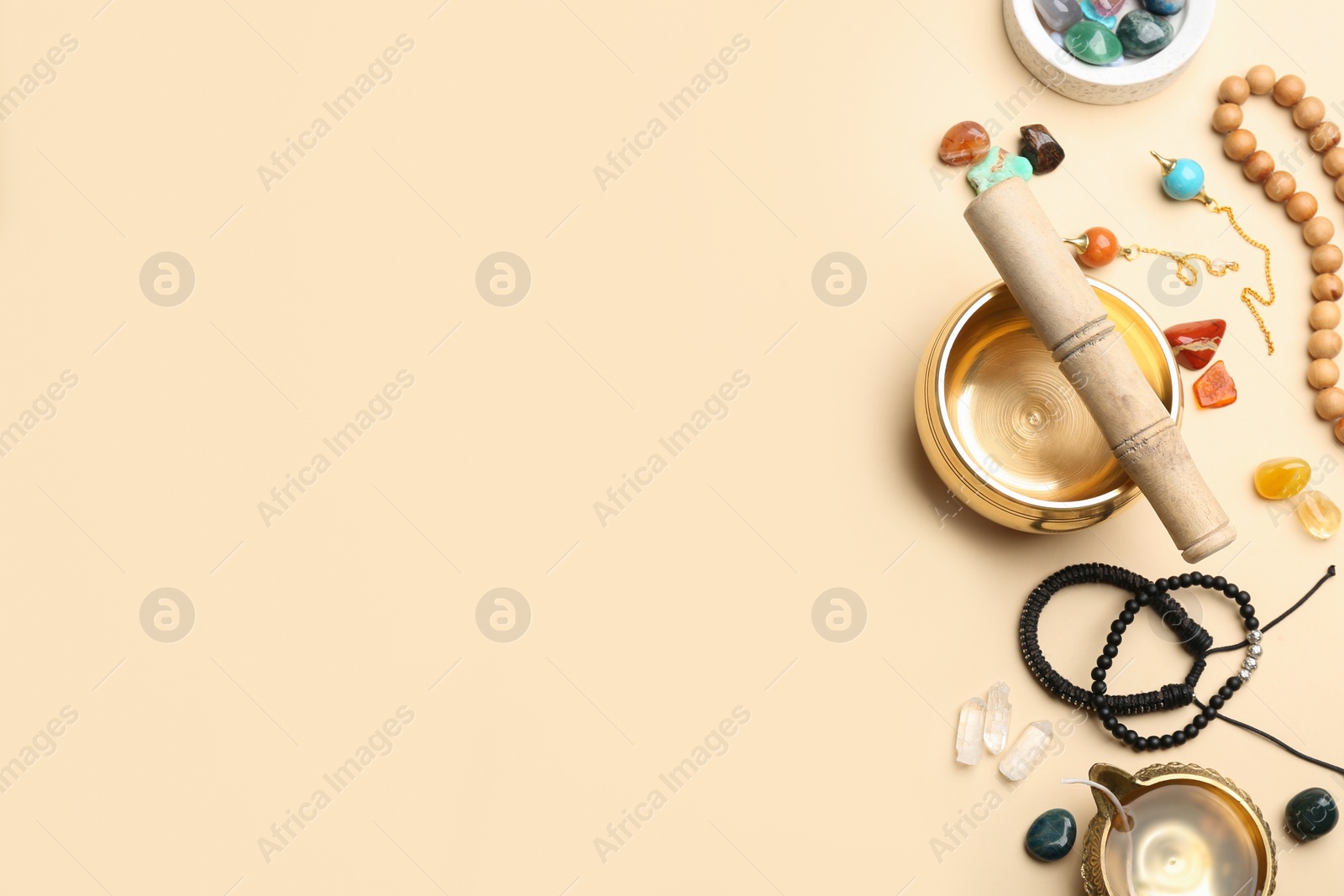 Photo of Flat lay composition with golden singing bowl on beige background, space for text. Sound healing