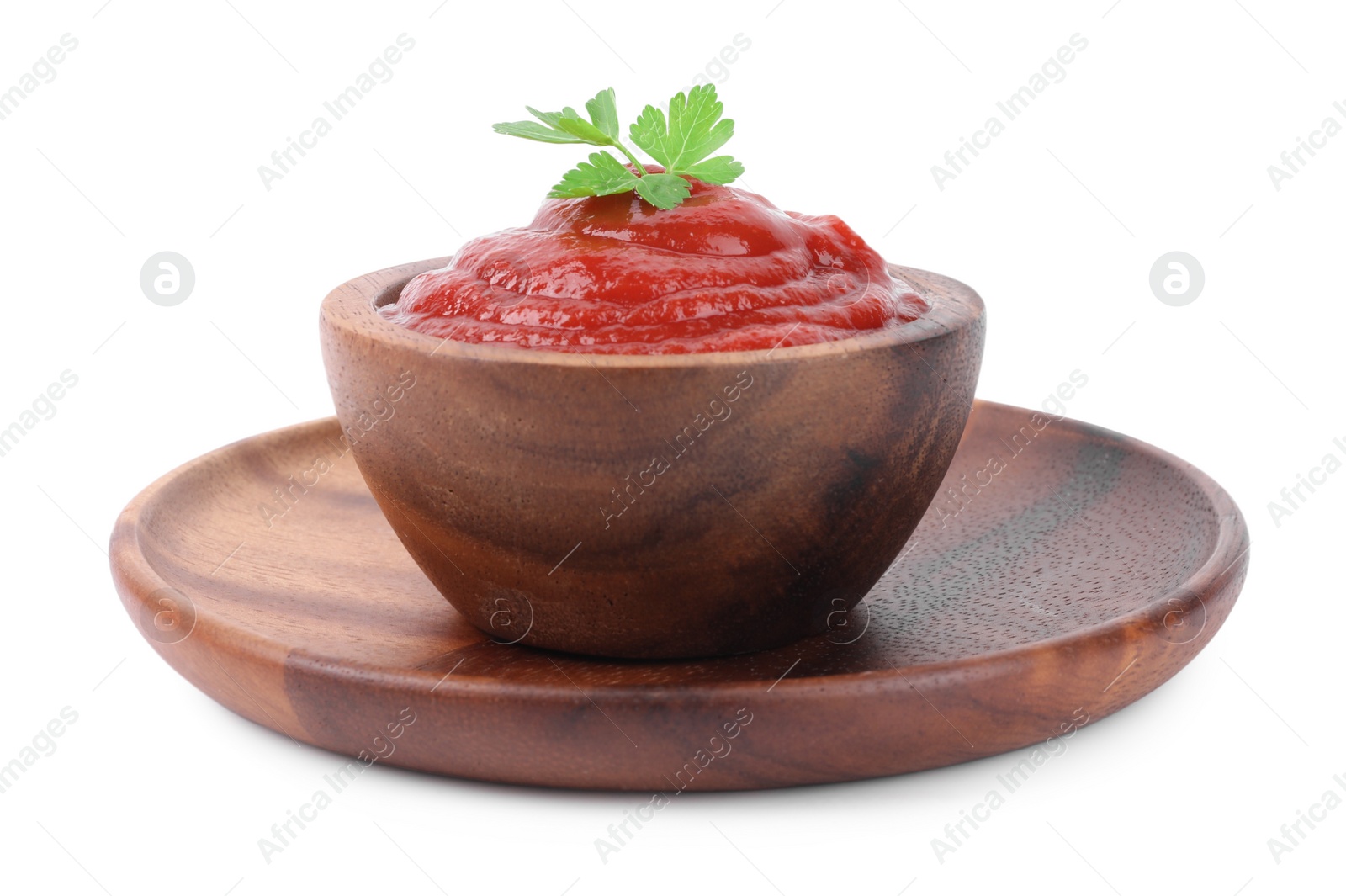 Photo of Organic ketchup and parsley in bowl isolated on white. Tomato sauce