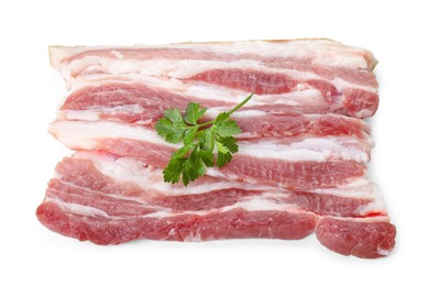 Pieces of raw pork belly and parsley isolated on white