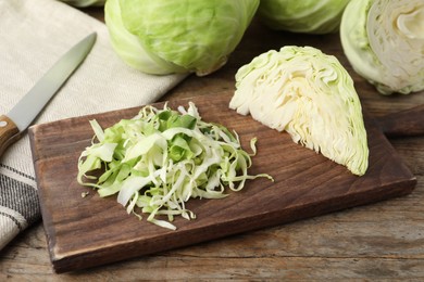 Photo of Chopped ripe white cabbage on wooden table