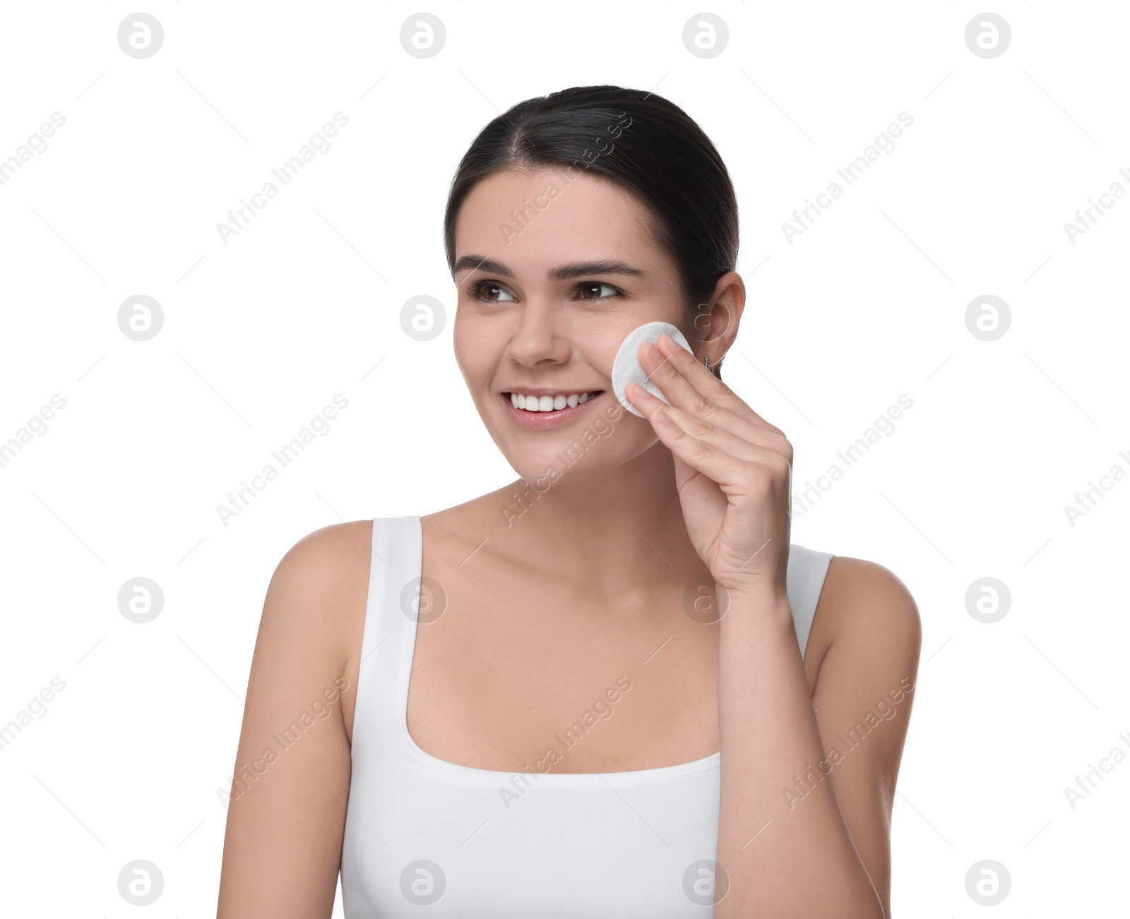 Photo of Young woman cleaning her face with cotton pad on white background