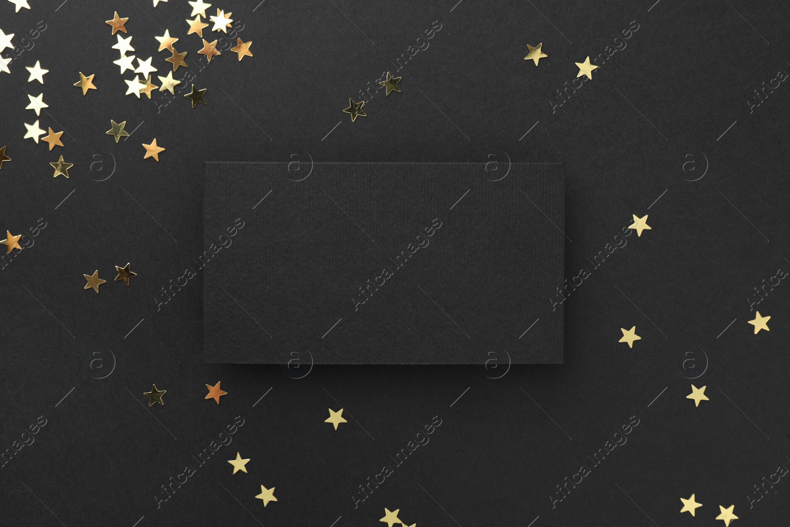 Photo of Blank business card and confetti on black background, top view. Mockup for design