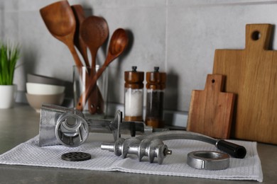 Photo of Clean parts of manual meat grinder on grey table indoors