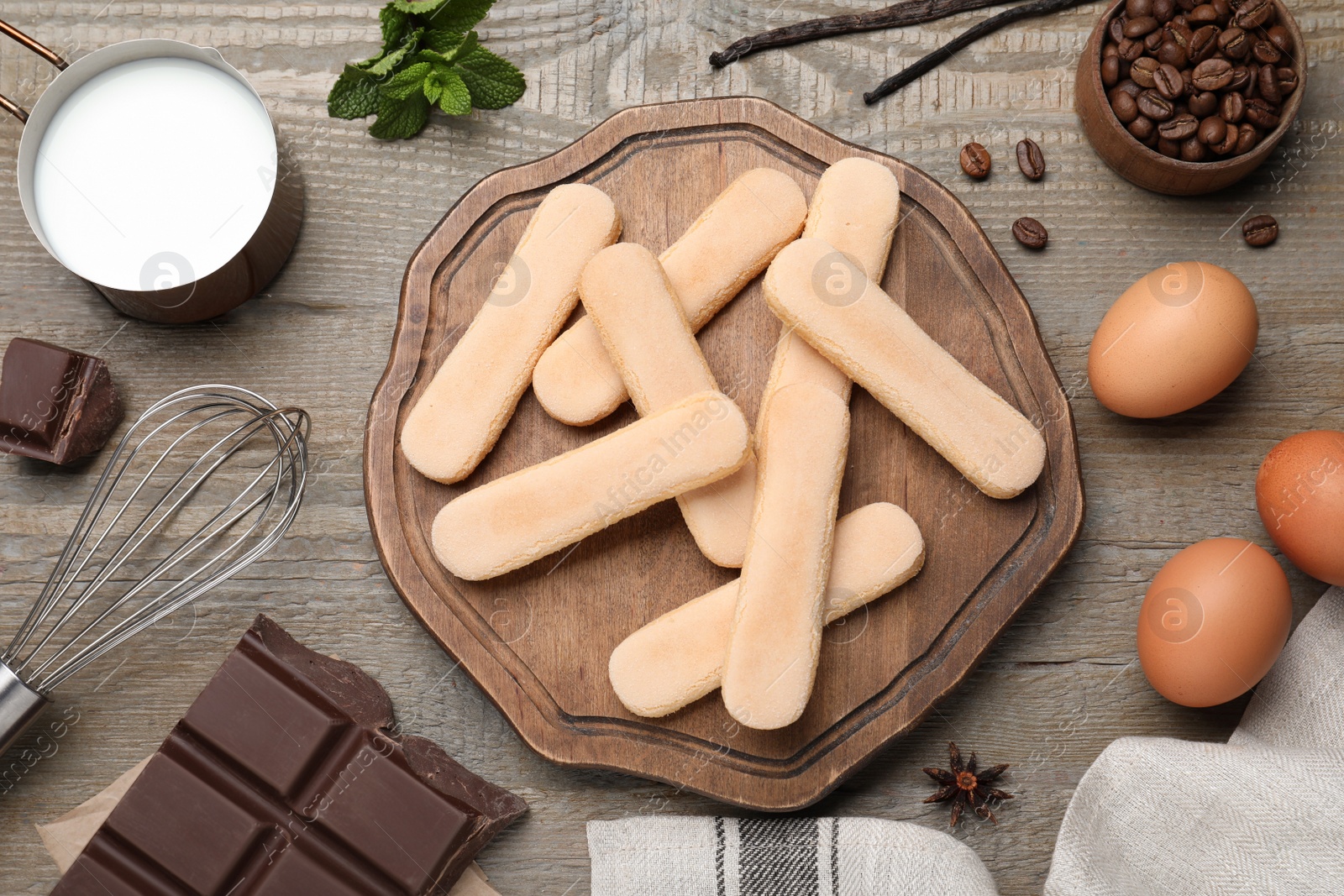 Photo of Flat lay composition with ingredients for tiramisu on wooden table