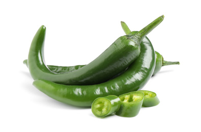 Photo of Cut and whole green hot chili peppers on white background