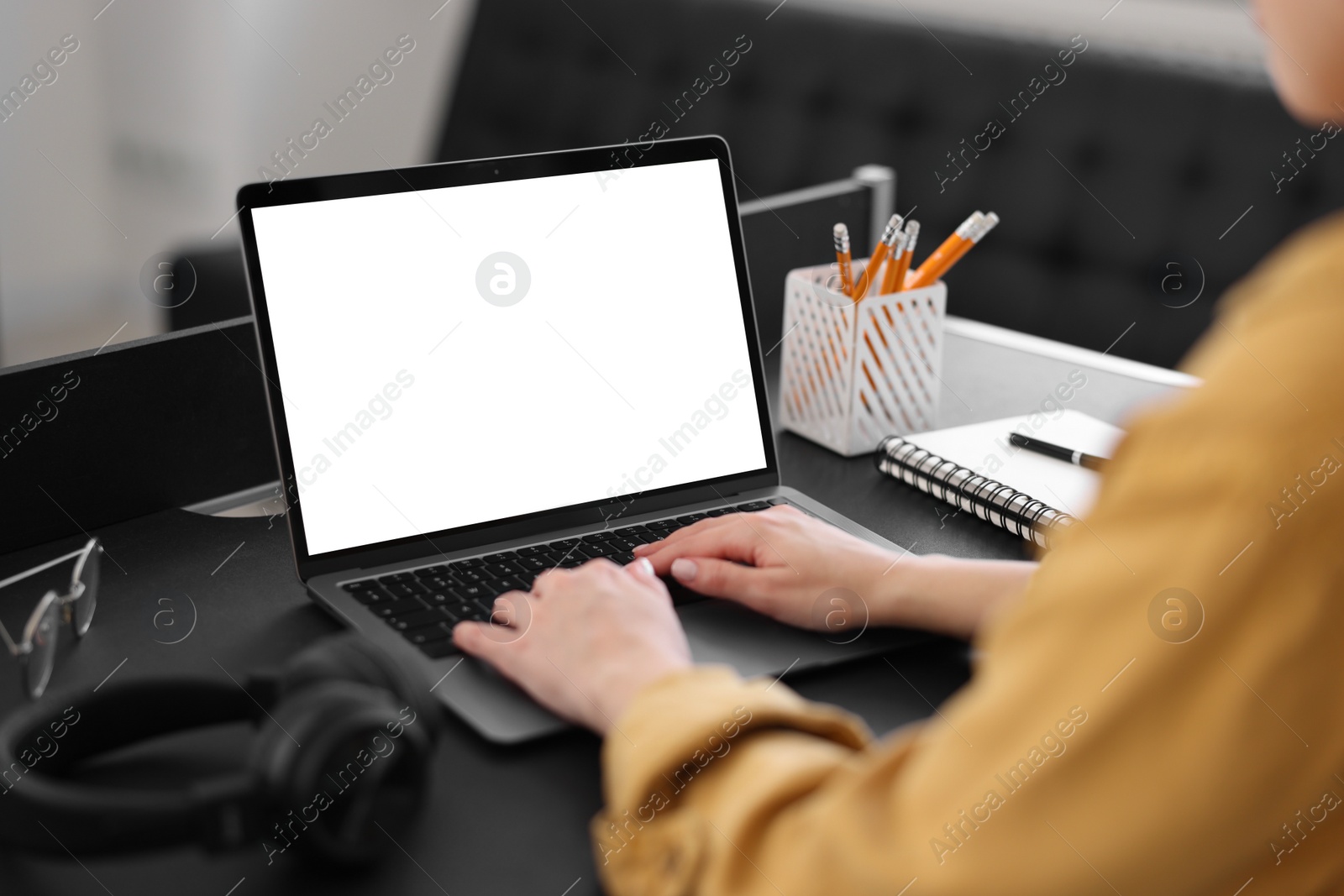 Photo of Woman watching webinar at table in office, closeup