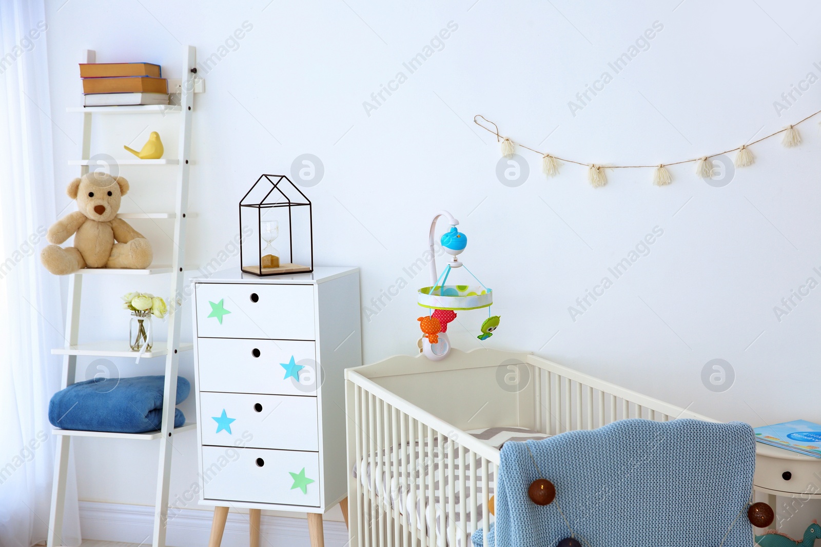 Photo of Cozy baby room interior with crib