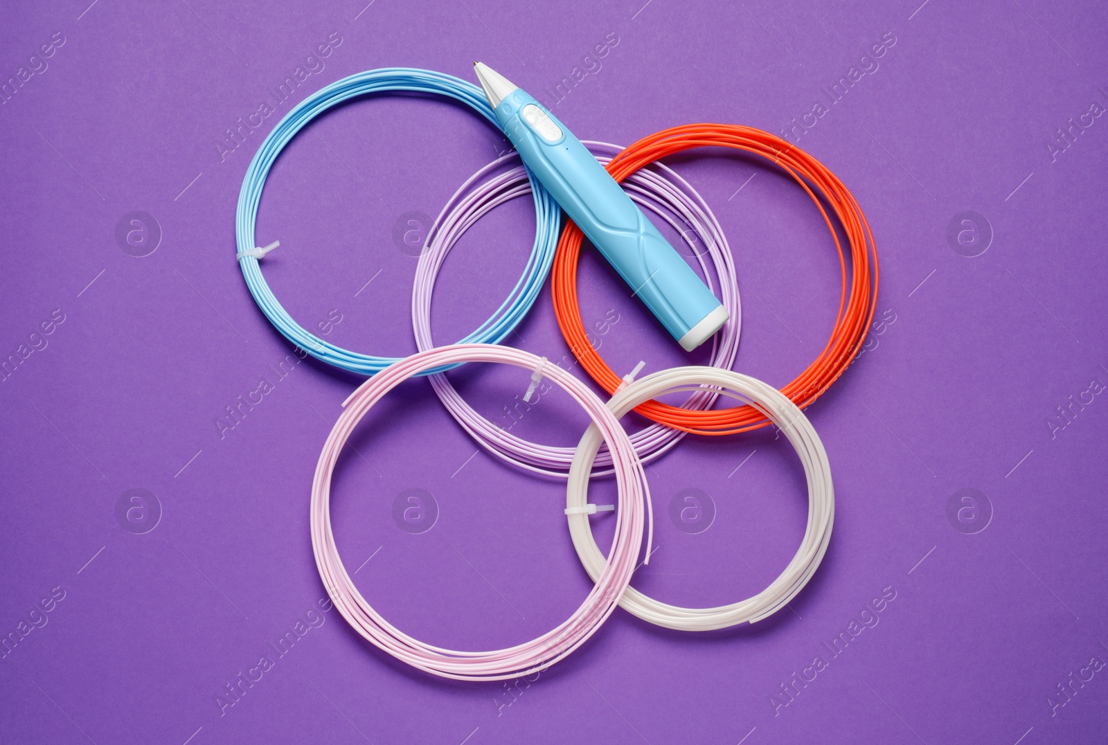 Photo of Stylish 3D pen and colorful plastic filaments on violet background, flat lay