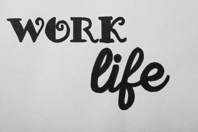 Photo of Work, Life written on white background, top view. Balance concept