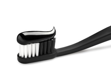 Photo of Brush with charcoal toothpaste isolated on white