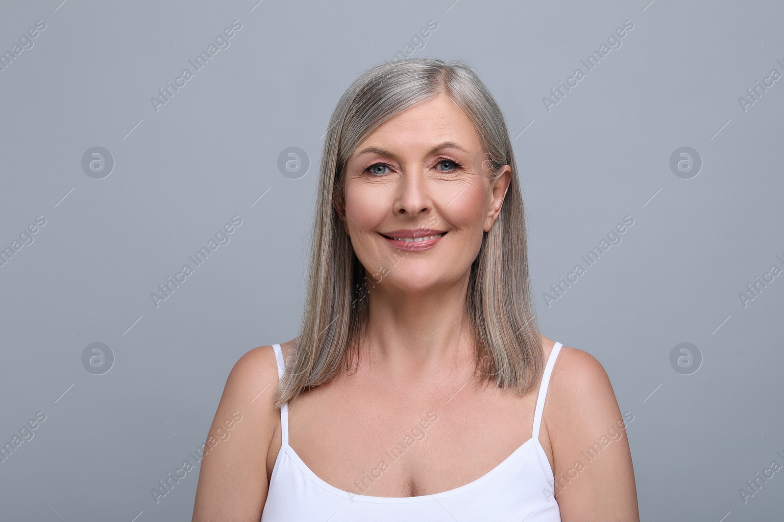 Photo of Portrait of beautiful senior woman on grey background